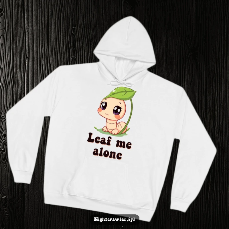 Funny hoodie depicting a cute worm character peeking from a dewy leaf with wide, curious eyes, radiating funny charm and gentle nature vibes.