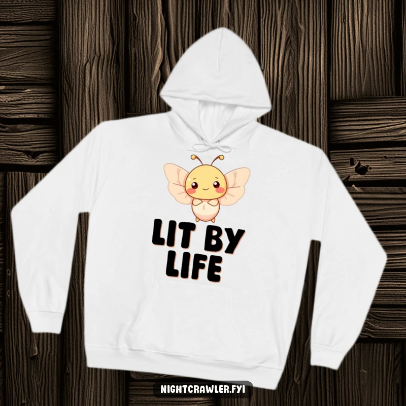 Funny moth hoodie featuring a happy character joyfully fluttering around a soft, gentle light source, perfect for cozy nights.